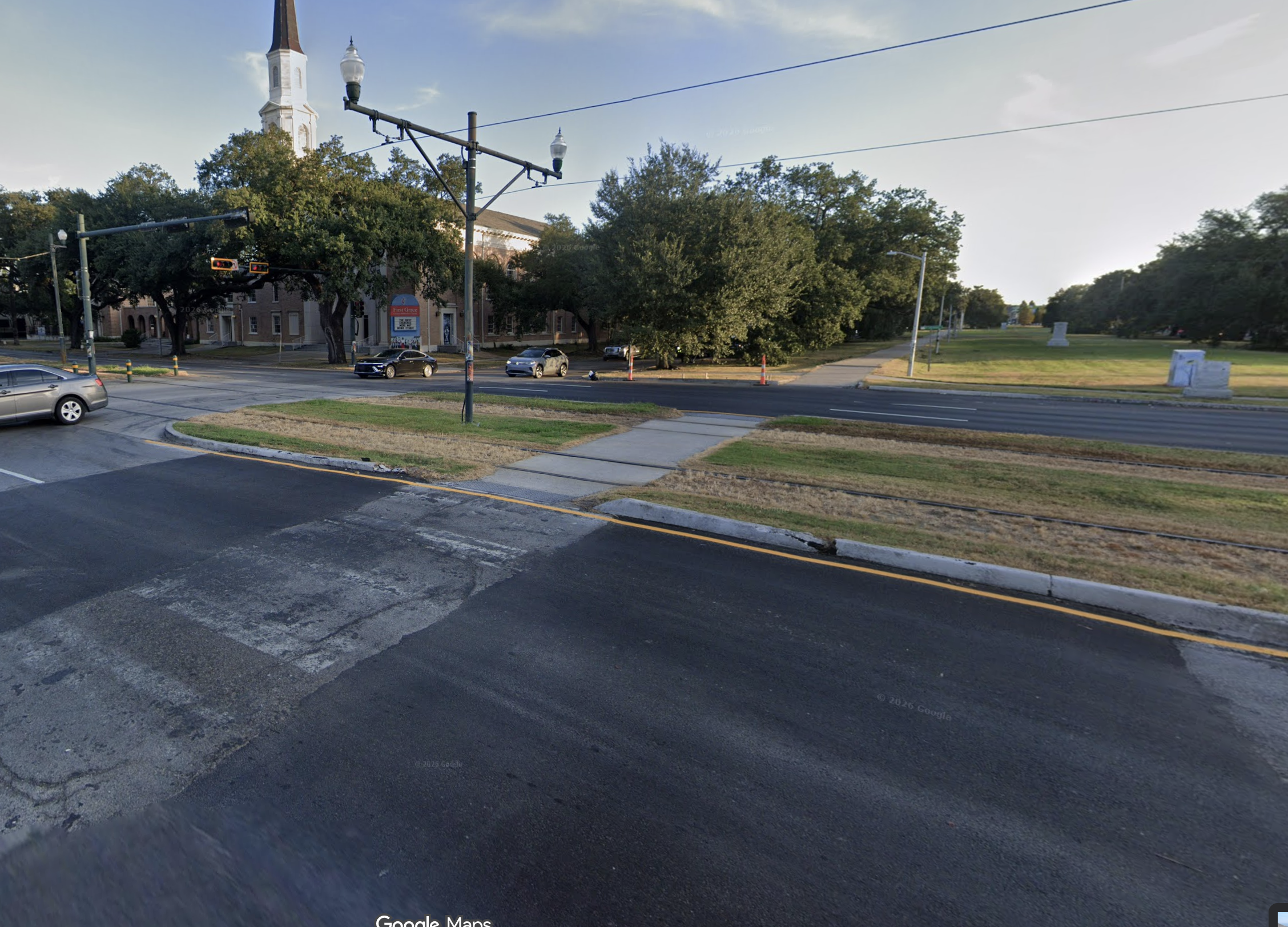 Intersection with faded crosswalk markings where the trail crosses the road