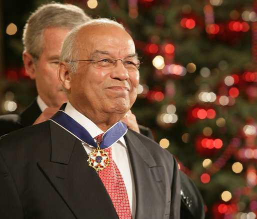Dr. Norman C. Francis receives the Presidential Medal of Freedom from President George W. Bush in the East Room of the White House, December 15, 2006.
