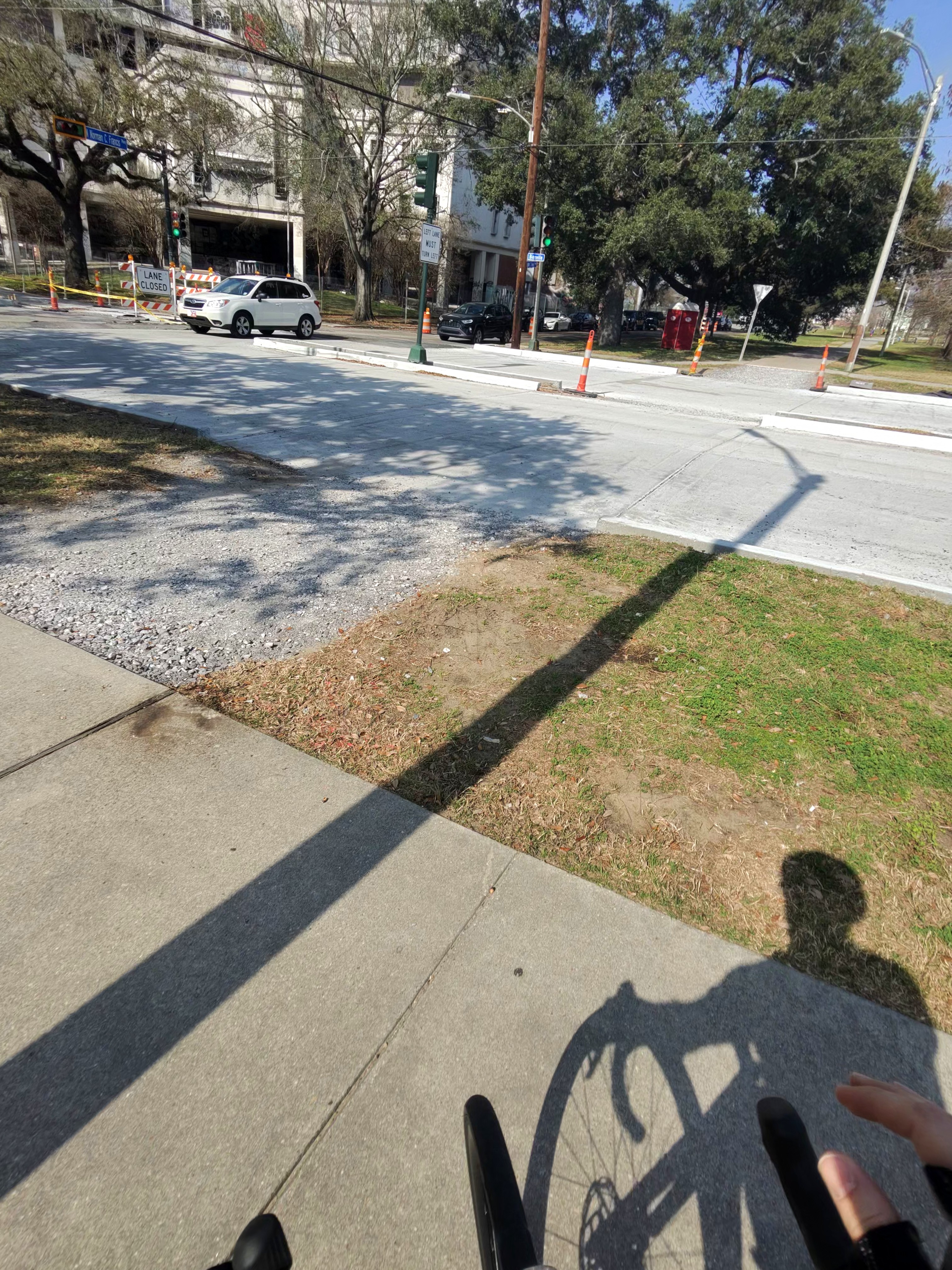 Gap in the trail where road construction left loose gravel instead of a connected path